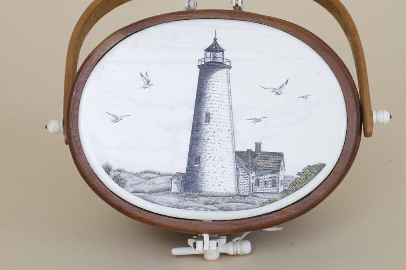 Miniture Nantucket Basket by Terry Silvia. The top of the basket has an Ivory Top with a scrimshaw polychrome Image of the "Great Point" Light House