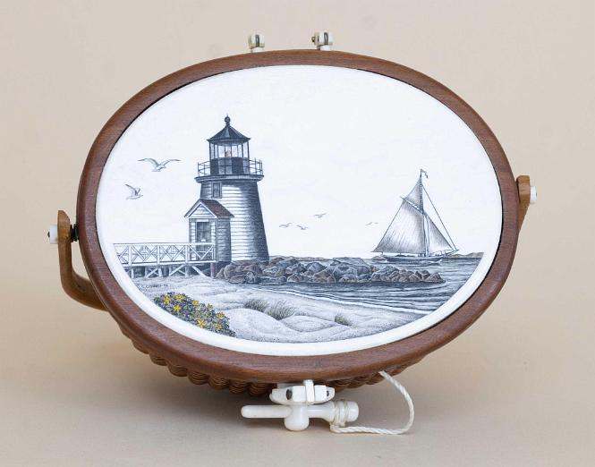 Miniature Nantucket Basket with Ivory Top by Terry Silvia. The basket has a polychrome scrimshaw image of "Brant Point" Lighthouse in Nantucket Harbor. 