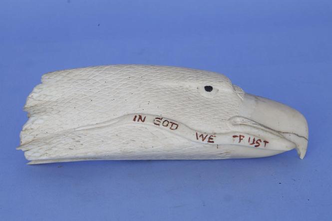 Carved Whales tooth Inscribed "IN GOD WE TRUST' in the Form of an Eagle, American 20th century